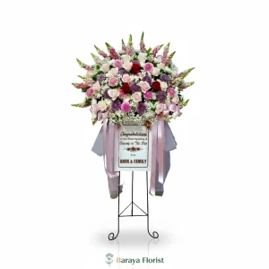 Standing flower warna pastel pink dan ungu elegan untuk grand opening dan ucapan selamat dengan desain anggun.